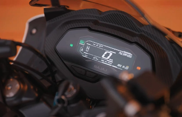 Close-up of a Bajaj motorcycle's digital dashboard display with orange background.