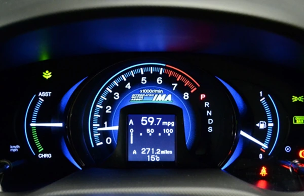 Illuminated car dashboard showing a tachometer, fuel efficiency at 59.7 mpg, and trip distance of 271.2 miles.