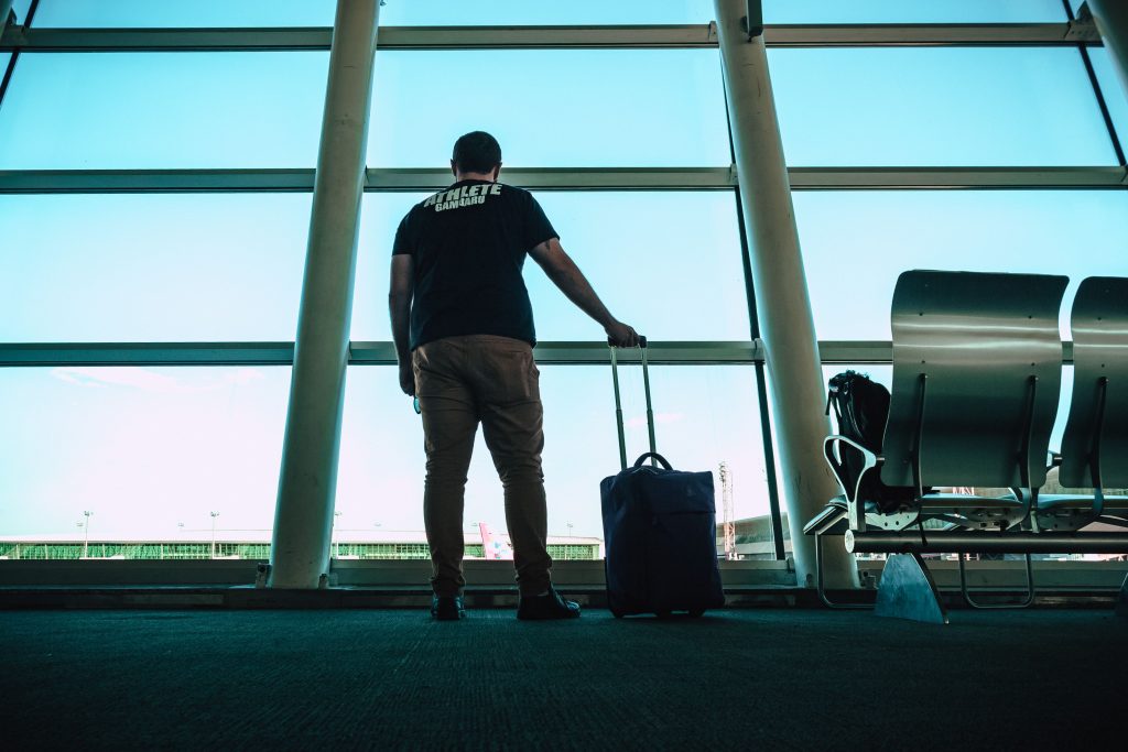 Missed Your Delta Flight? Man holding a suitcase at an airport